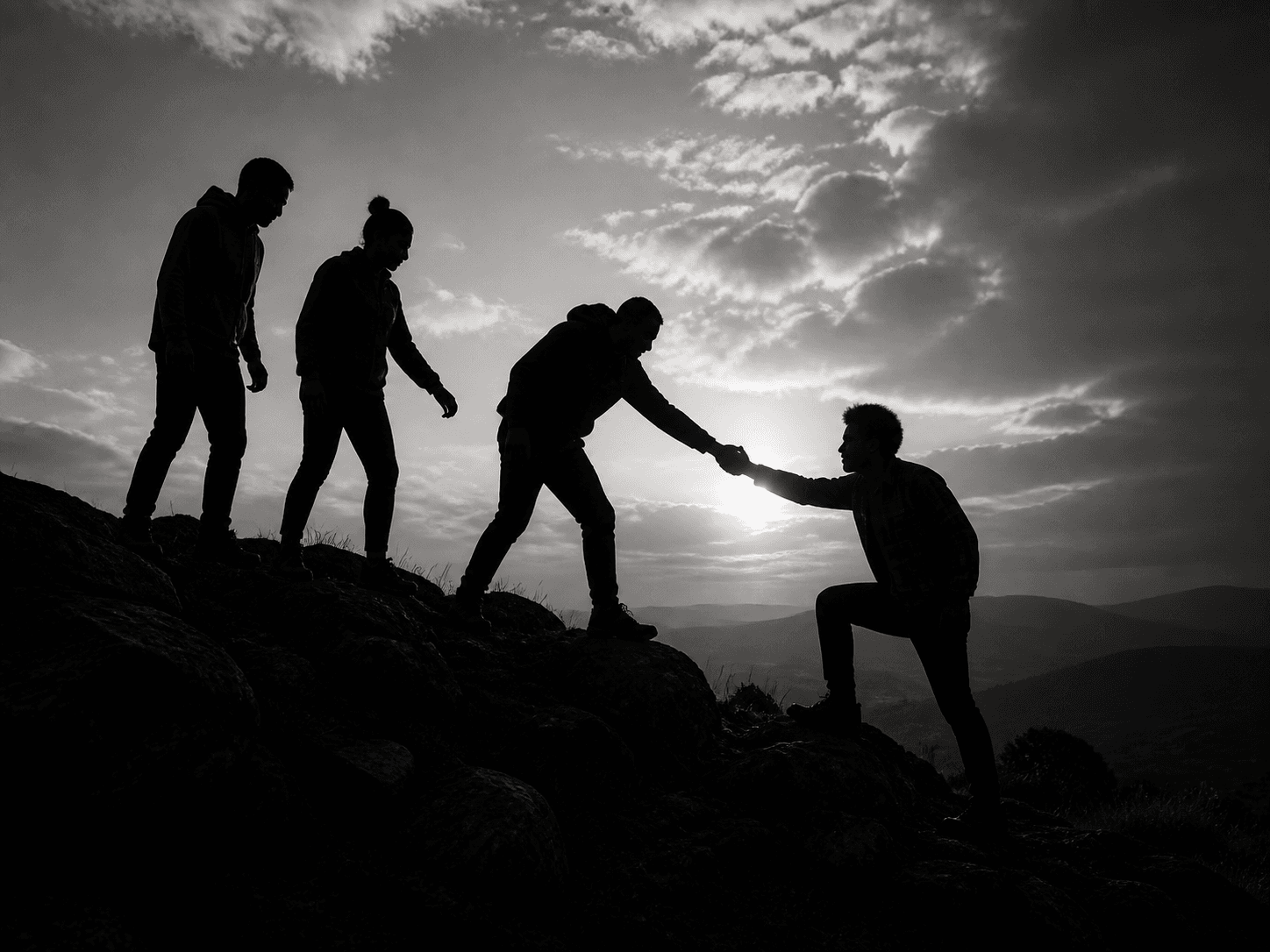 People supporting one another on a hillside